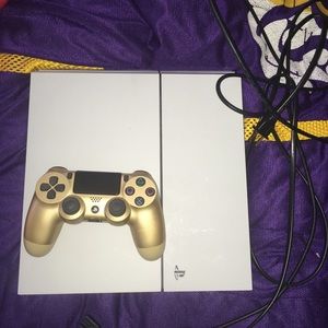 White sony playstation 4 with gold controller .